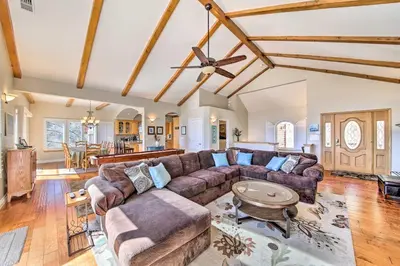 a living room with a couch and a table at Mountain Gem with Game Room, 5 Mi to Lake Arrowhead! in Lake Arrowhead