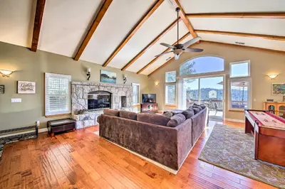 a living room with a couch and a fireplace at Mountain Gem with Game Room, 5 Mi to Lake Arrowhead! in Lake Arrowhead