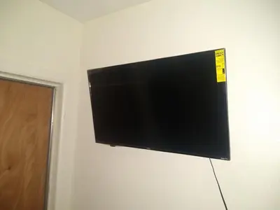 a flat screen tv hanging on a wall at Home Sweet Home in Colton
