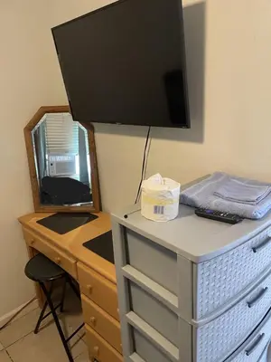 a desk with a television on top of a dresser at Home Sweet Home in Colton