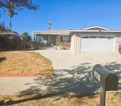 a house with a parking meter in front of a driveway at Home Sweet Home in Colton