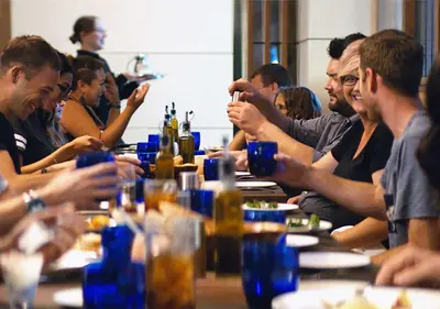 a group of people sitting at a table with drinks at Luskin Hotel in Los Angeles