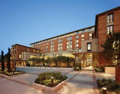 a building with a courtyard in front of it at Luskin Hotel in Los Angeles