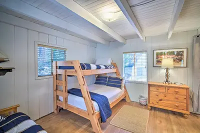 a bedroom with a bunk bed with a ladder at Lakeview Lodge Fit for Groups Less Than 1 Mile to Lake! in Lake Arrowhead