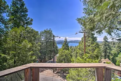 a wooden deck with a view of the water at Lakeview Lodge Fit for Groups Less Than 1 Mile to Lake! in Lake Arrowhead