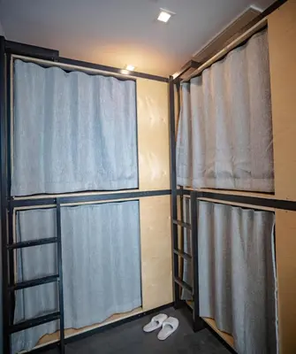 a room with two curtains and a pair of shoes at Haven Coliving in Los Angeles