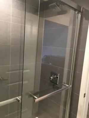 a shower with a glass door in a bathroom at PASADENA LODGE in Pasadena