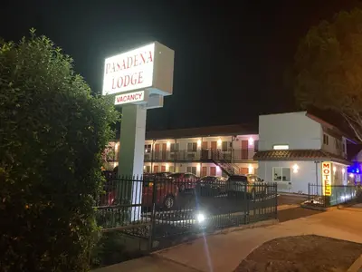 a sign in front of a hotel at night at PASADENA LODGE in Pasadena