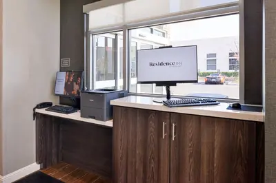 an office with a computer on a desk with a window at Residence Inn by Marriott Bakersfield West in Bakersfield