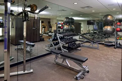 a gym with several tread machines and mirrors at Residence Inn by Marriott Bakersfield West in Bakersfield