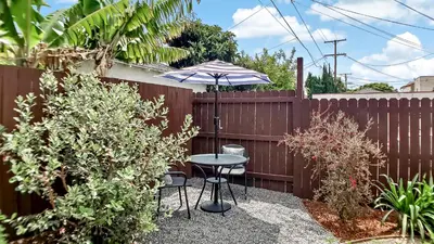 a patio with a table and an umbrella at Top Location Walk to Dining, Shops & Near Beach CC E in Culver City