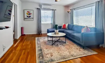 a living room with a blue couch and a table at Top Location Walk to Dining, Shops & Near Beach CC E in Culver City