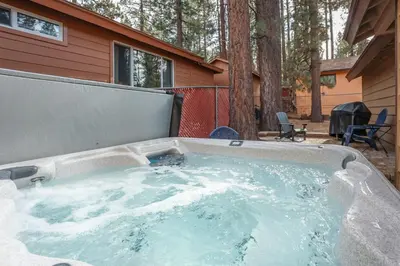 a hot tub in front of a house at Bohemia Big Bear-1926 by Big Bear Vacations in Big Bear Lake