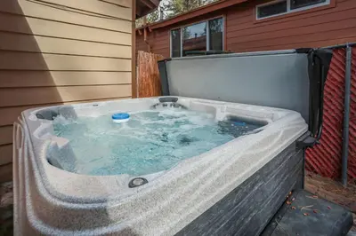 a hot tub in the back of a house at Bohemia Big Bear-1926 by Big Bear Vacations in Big Bear Lake