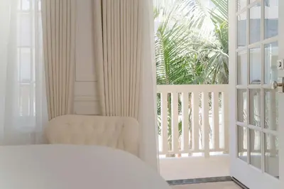 a bedroom with a bed and a sliding glass door at Cara Hotel in Los Angeles