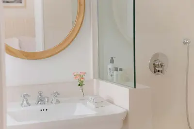 a bathroom with a sink and a mirror at Cara Hotel in Los Angeles