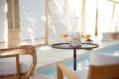 a table with two glasses of wine and a bottle at Cara Hotel in Los Angeles