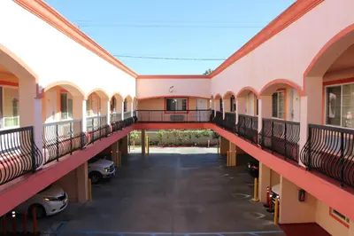 an empty hallway of a building with cars parked at ERTH INN by AGA Maywood in Maywood