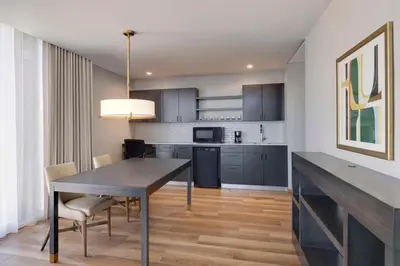 a kitchen and dining room with a table and chairs at Hyatt House LAX Century Blvd in Los Angeles