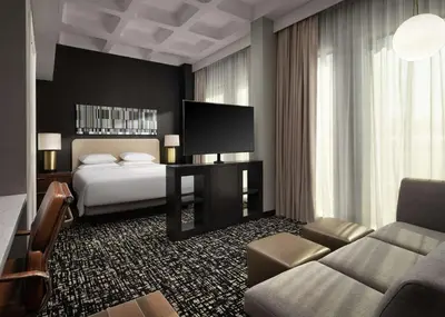 a hotel room with a bed and a television at Hyatt House LAX Century Blvd in Los Angeles