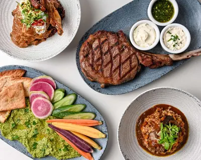 a table with plates of food with meat and dips at Hyatt Place LAX/Century BLVD in Los Angeles