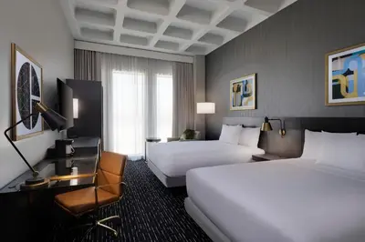 a hotel room with two beds and a chair at Hyatt Place LAX/Century BLVD in Los Angeles