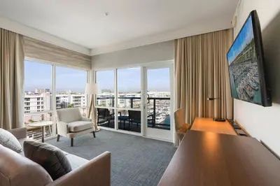 a living room with a couch and a large window at Residence Inn by Marriott Marina del Rey in Los Angeles
