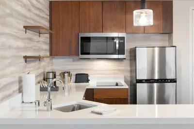 a kitchen with a sink and a refrigerator at Residence Inn by Marriott Marina del Rey in Los Angeles