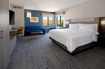 a bedroom with a large bed and a blue wall at Holiday Inn Express & Suites - Valencia - Santa Clarita by IHG in Valencia