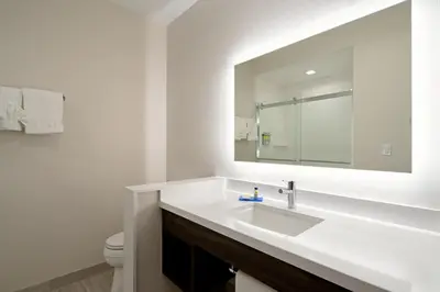 a white bathroom with a sink and a mirror at Holiday Inn Express & Suites - Valencia - Santa Clarita by IHG in Valencia