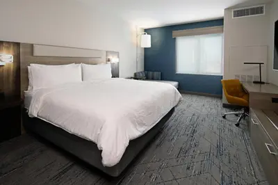 a hotel room with a large bed and a desk at Holiday Inn Express & Suites - Valencia - Santa Clarita by IHG in Valencia