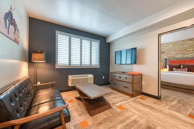 a bedroom with a couch and a mirror and a bed at Hotel Lexen Newhall & Santa Clarita - Near Six Flags Magic Mountain in Santa Clarita