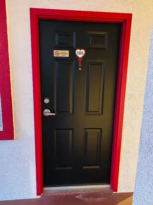 a black door with a heart sign on it at Casa Valentine Inn - Los Angeles in Los Angeles