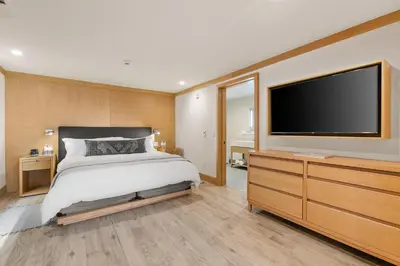 a bedroom with a bed and a flat screen tv at SA Carbon Beach Suites in Malibu
