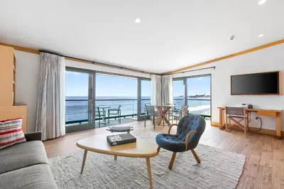 a living room with a view of the ocean at SA Carbon Beach Suites in Malibu