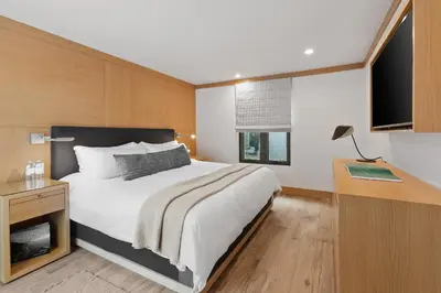 a bedroom with a bed and a desk and a television at SA Carbon Beach Suites in Malibu