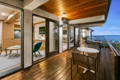 a house with a balcony with a view of the ocean at SA Carbon Beach Suites in Malibu