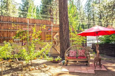a red umbrella and a chair and a giraffe at Eagle's Nest in Big Bear Lake