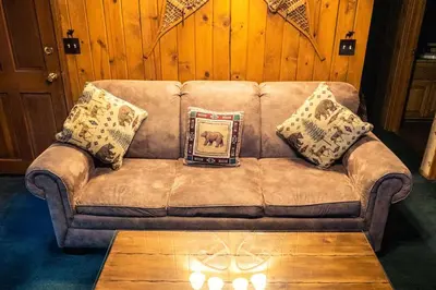 a couch in a living room with a picture on it at Eagle's Nest in Big Bear Lake