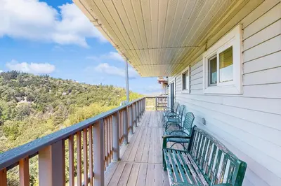 a row of benches sitting on a balcony at Lake View Magic in Crestline