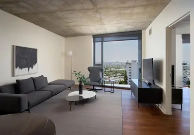 a living room with a couch and a tv at AKA West Hollywood in Los Angeles
