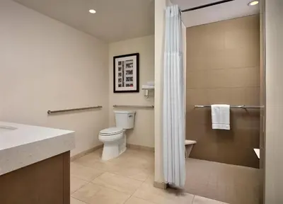 a bathroom with a toilet and a shower at Hyatt House LA - University Medical Center in Los Angeles