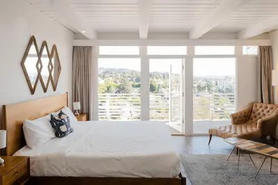 a bedroom with a bed and a large window at Hollywood Hills Hotel in Los Angeles