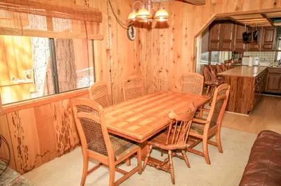 a dining room with a wooden table and chairs at A Big Olympic Getaway apts in Big Bear Lake
