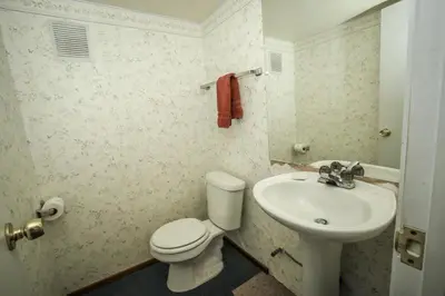 a bathroom with a white toilet and a sink at A Big Olympic Getaway apts in Big Bear Lake