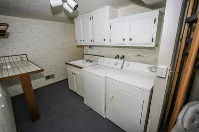 a kitchen with white cabinets and white appliances at A Big Olympic Getaway apts in Big Bear Lake