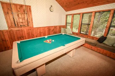 a room with a pool table in a house at A Big Olympic Getaway apts in Big Bear Lake