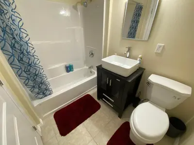 a bathroom with a white toilet and a sink at Casa Tranquila in Santa Ana