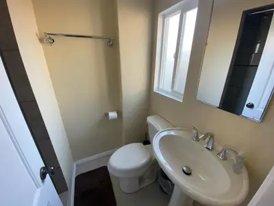 a bathroom with a sink and a toilet and a mirror at Casa Tranquila in Santa Ana
