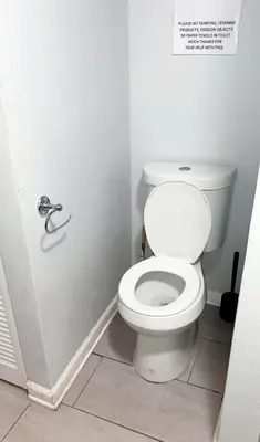 a bathroom with a white toilet in a stall at Casa Tranquila in Santa Ana